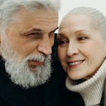 Close-up of a joyful senior couple showing love and togetherness, embracing warmly.